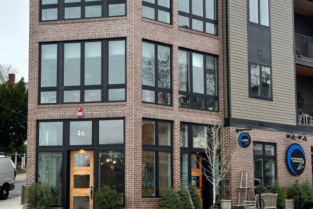 Roslindale Mixed Use residential & retail building featuring a brick facade