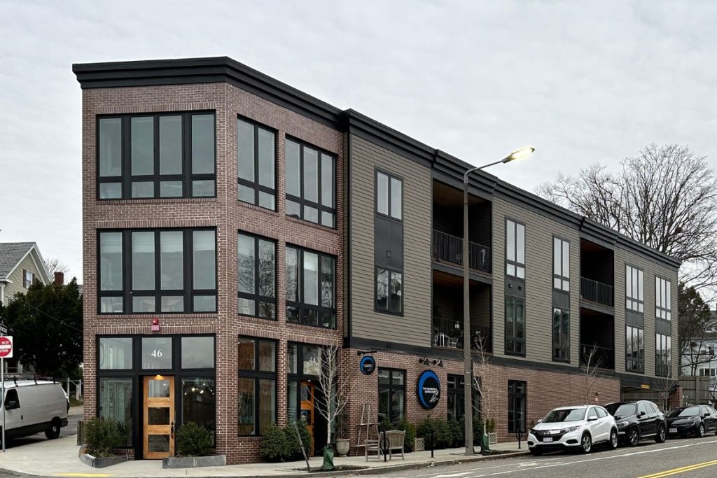 Red brick and black framed windows exterior at a Choo Designed Roslindale mixed use development