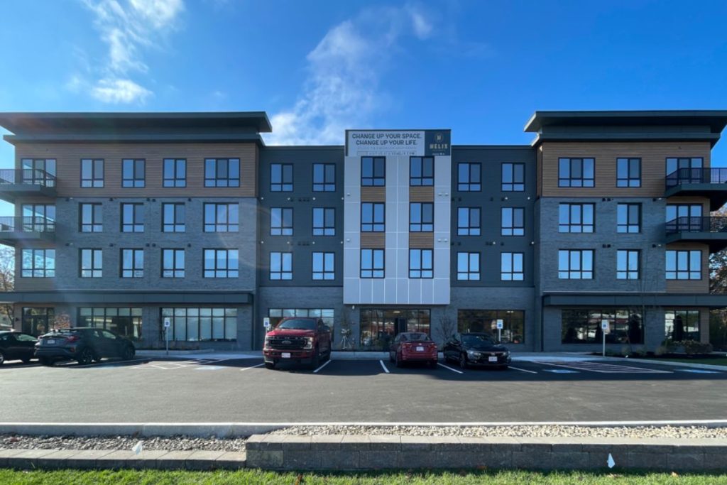 Exterior of large mixed use development in Weymouth with ground floor retail and tree stories of residential above