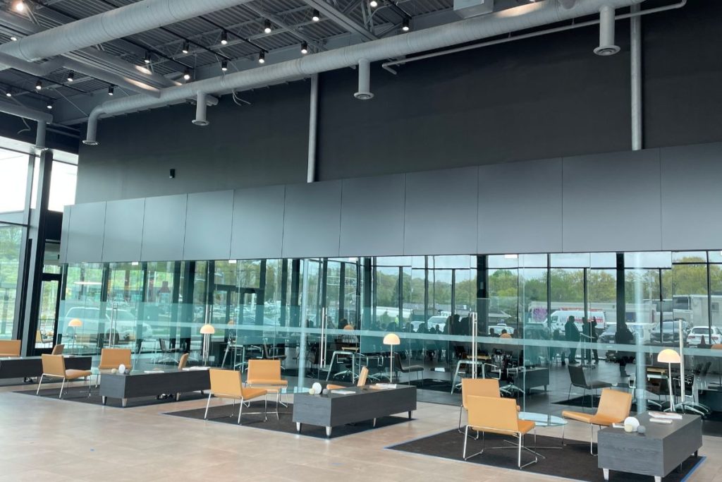 Sales team area at the Genesis Braintree Car Dealership with modern desks and glass walls