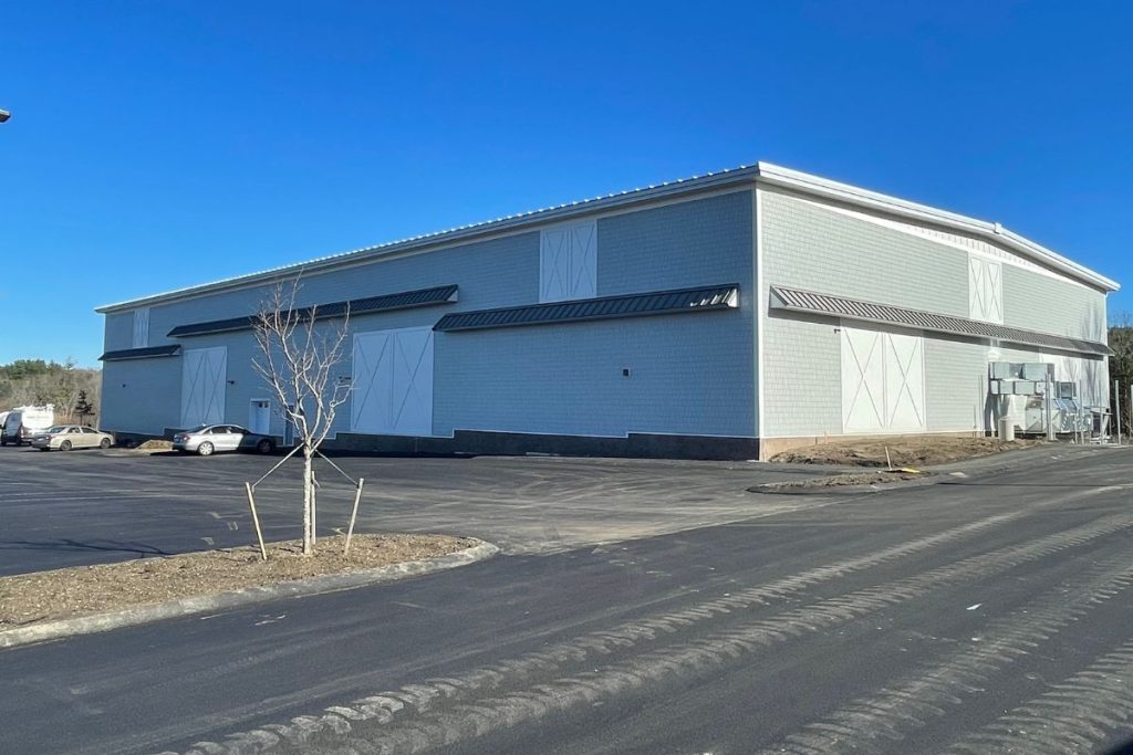 Rear and side of a Westborough Sports Facility with grey siding.