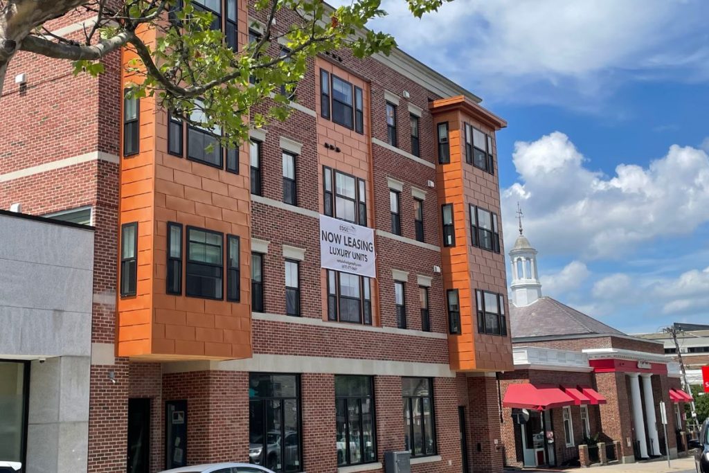 Luxury exterior of 4 story mixed use apartment block in South Boston with copper cladding and red brick exterior