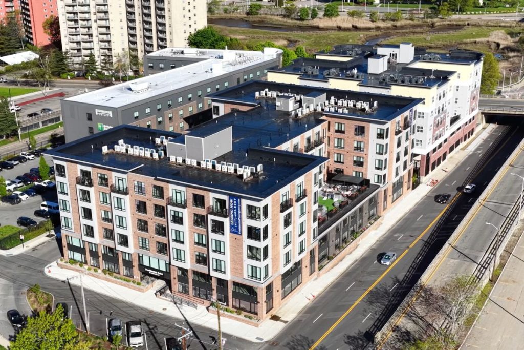 Drone footage of architectural designed mixed use residential building in Quincy, MA.