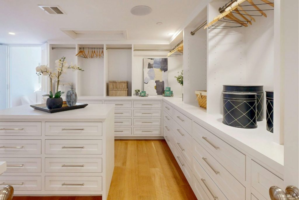 Closet makeover in historic home in Beacon Hill featuring ample storage and white cabinetry