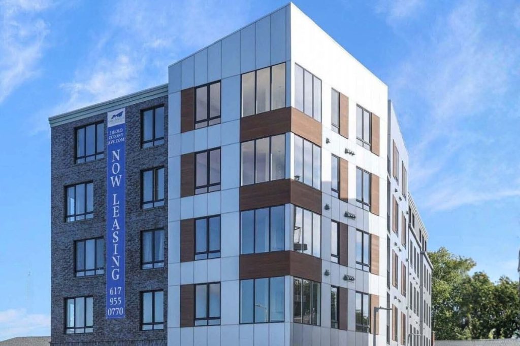 South Boston mixed use residential building exterior with a mix of brick, white and wood paneling.
