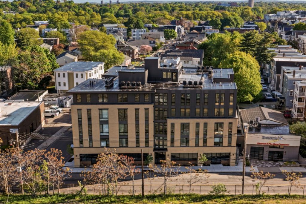 Arial view of large condo building in Brighton MA designed by architects opposite the New Balance Building.
