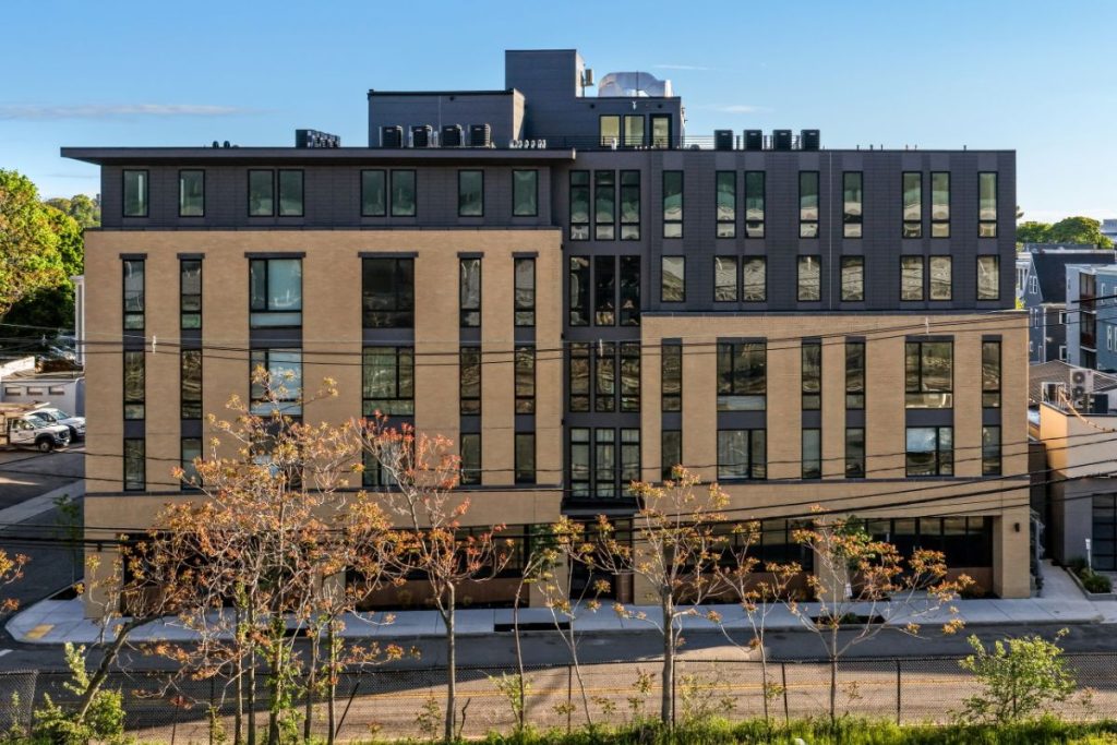 Brick and dark features on a large condo building exterior in Brighton MA